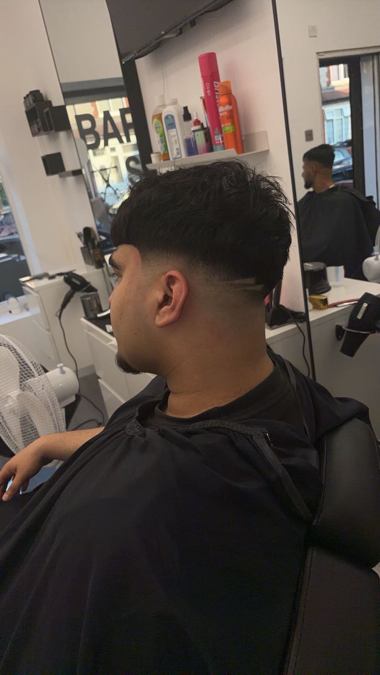 Taper fade with a sharp side part line