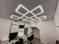 HP CUTZ interior, signature diamond ceiling lighting above the barber chairs
